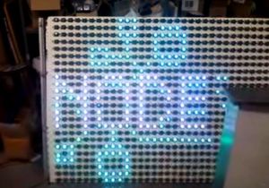 A pixel-art version of the Baltimore Node logo rendered on a wall of LED's, an array of RGB Christmas lights.